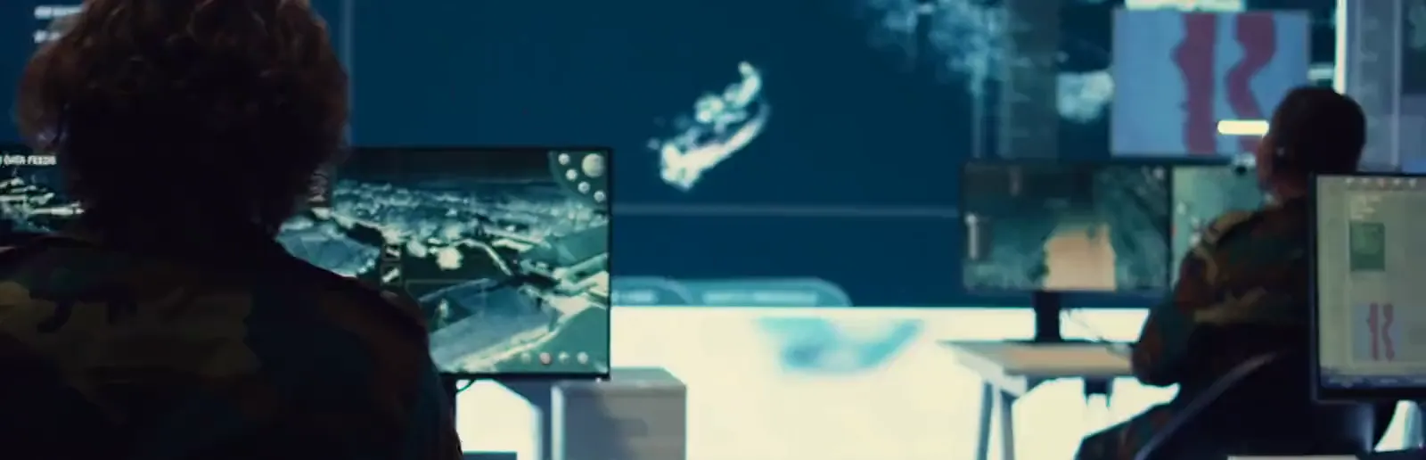 Military operations room with satellite reconnaissance displays