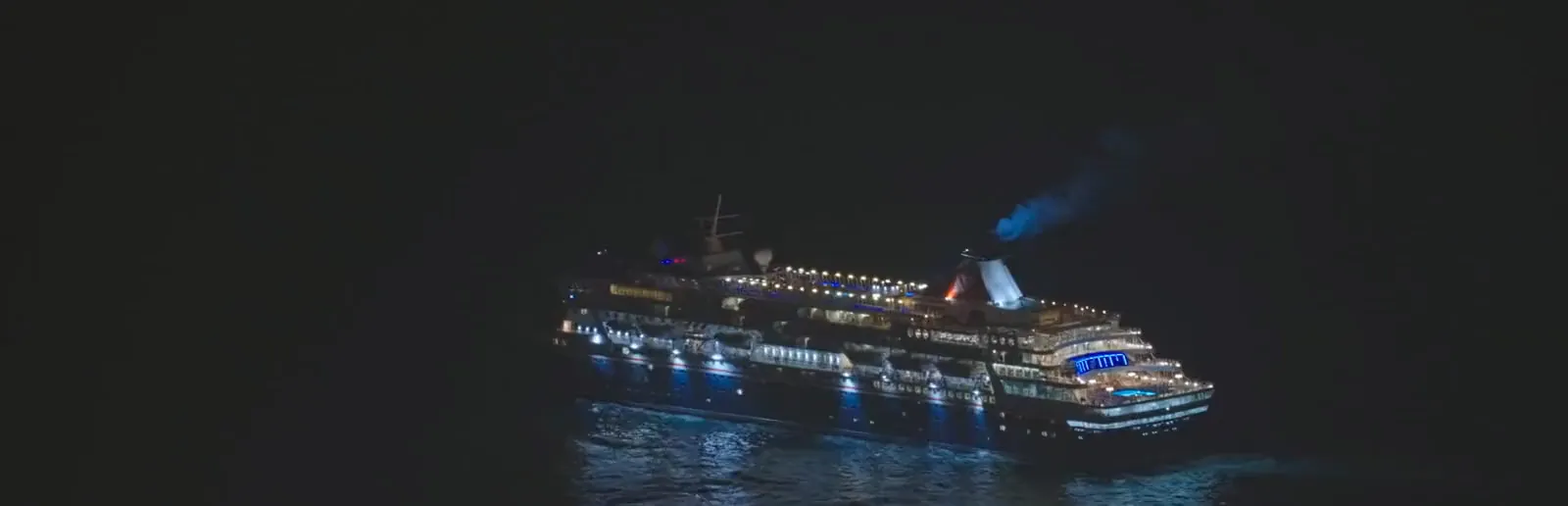 Aerial view of an illuminated ship at night